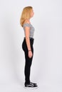 Full body shot profile view of young beautiful blonde teenage girl Royalty Free Stock Photo