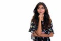 Studio shot of young beautiful Persian woman thinking while look