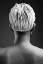 Young beautiful rebellious woman with short hair against gray ba Royalty Free Stock Photo