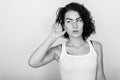 Studio shot of beautiful teenage girl thinking while listening against green painted wall Royalty Free Stock Photo