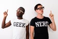 Studio shot of young black African Geek man with European Nerd m Royalty Free Stock Photo