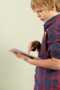 Studio Shot Of Young Boy Holding Tablet Computer Royalty Free Stock Photo