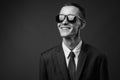 Portrait of young businessman with sunglasses against gray background Royalty Free Stock Photo