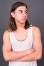 Young handsome androgynous man with long hair Royalty Free Stock Photo