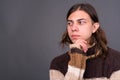 Young androgynous man with long hair ready for winter Royalty Free Stock Photo