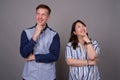 Portrait of happy multi ethnic diverse couple thinking while smiling Royalty Free Stock Photo