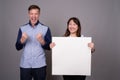 Portrait of multi ethnic diverse couple in studio showing copy space Royalty Free Stock Photo