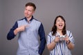 Portrait of multi ethnic diverse couple playing video games Royalty Free Stock Photo