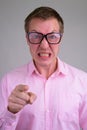 Face of angry young nerd businessman pointing at camera Royalty Free Stock Photo