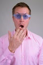 Face of surprised young businessman wearing blue novelty glasses Royalty Free Stock Photo