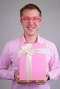 Portrait of happy young handsome businessman holding gift box Royalty Free Stock Photo