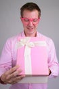 Portrait of young happy businessman opening gift box Royalty Free Stock Photo