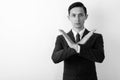 Studio shot of young handsome businessman showing stop hand gesture with both arms against white background Royalty Free Stock Photo