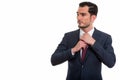 Studio shot of young handsome businessman thinking and looking a Royalty Free Stock Photo