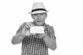 Studio shot of young handsome Caucasian man taking picture with mobile phone isolated against white background Royalty Free Stock Photo