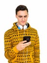 Studio shot of young handsome Caucasian man using phone isolated against white background Royalty Free Stock Photo