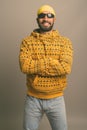 Young handsome Indian man against gray background Royalty Free Stock Photo