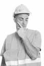 Studio shot of young handsome man construction worker thinking Royalty Free Stock Photo