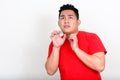 Portrait of stressed young overweight Asian man looking scared Royalty Free Stock Photo