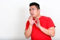 Portrait of stressed young overweight Asian man looking scared Royalty Free Stock Photo