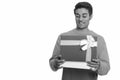 Young happy Persian man opening gift box ready for Valentine`s day Royalty Free Stock Photo