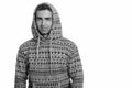 Studio shot of young handsome Persian man wearing hoodie