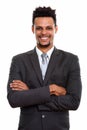 Studio shot of young happy African businessman smiling with arms Royalty Free Stock Photo