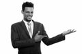 Studio shot of young happy African businessman smiling while showing something Royalty Free Stock Photo