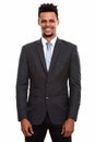 Studio shot of young happy African businessman smiling while st Royalty Free Stock Photo