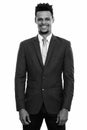 Studio shot of young happy African businessman smiling while standing Royalty Free Stock Photo