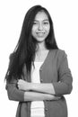 Studio shot of young happy Asian teenage girl smiling with arms crossed Royalty Free Stock Photo