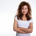 Studio shot of young happy Asian woman smiling with arms crossed Royalty Free Stock Photo