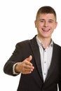 Studio shot of young happy businessman smiling and giving handsh