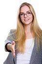 Studio shot of young happy businesswoman smiling while giving ha Royalty Free Stock Photo