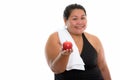 Studio shot of young happy fat Asian woman smiling while giving Royalty Free Stock Photo