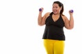 Studio shot of young happy fat Asian woman smiling and raising b Royalty Free Stock Photo