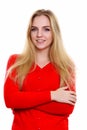 Studio shot of young happy teenage girl smiling with arms crosse Royalty Free Stock Photo