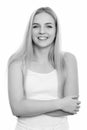 Studio shot of young happy teenage girl smiling with arms crossed Royalty Free Stock Photo