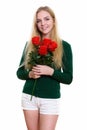 Studio shot of young happy teenage girl smiling while holding re Royalty Free Stock Photo