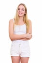 Studio shot of young happy teenage girl smiling while standing w Royalty Free Stock Photo