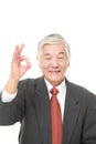 Senior Japanese businessman showing perfect sign Royalty Free Stock Photo