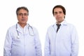 Studio shot of young man doctor with senior Persian man doctor