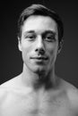 Studio shot of young muscular handsome man shirtless in black an Royalty Free Stock Photo