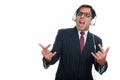 Studio shot of young Persian businessman listening to music with