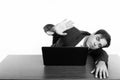 Studio shot of young Persian businessman sleeping while showing stop hand sign with laptop on wooden table Royalty Free Stock Photo