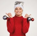 Christmas ornaments represent a gift of love given a long time ago. Studio shot of a young woman holding Christmas decor Royalty Free Stock Photo