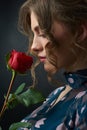 Sideview of a beatiful girl with red rose. Royalty Free Stock Photo