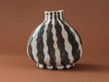 Studio still life of a handbuilt ceramic vase with expressive black striped pattern Royalty Free Stock Photo