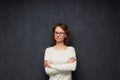 Portrait of confident young woman holding arms crossed on chest Royalty Free Stock Photo