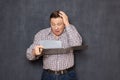 Portrait of dumbfounded bewildered man looking at documents